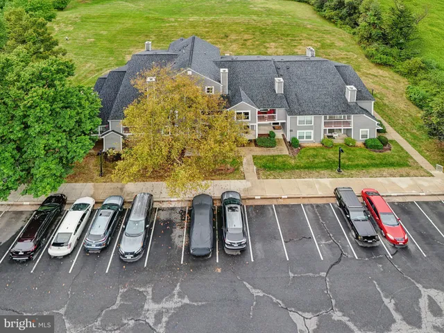 an aerial view of a house with a yard basket ball court and outdoor seating