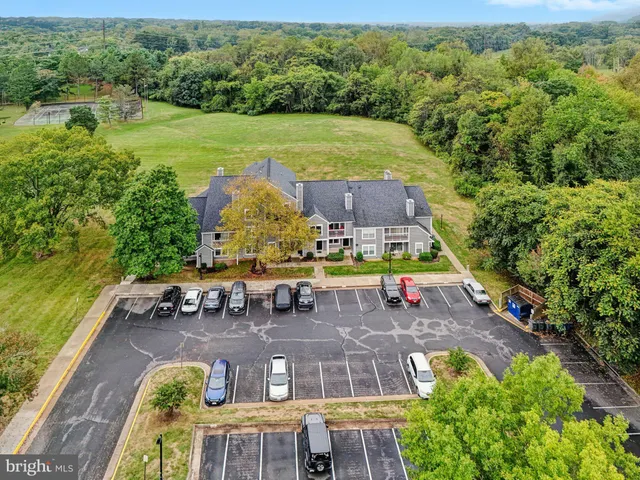 an aerial view of a house with a garden and swimming pool