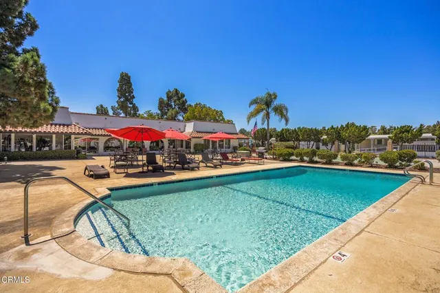 a view of a swimming pool and lounge chairs