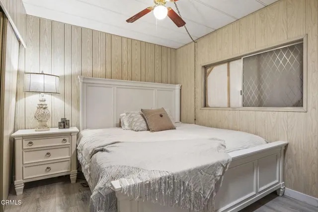 a bedroom with a bed and a window