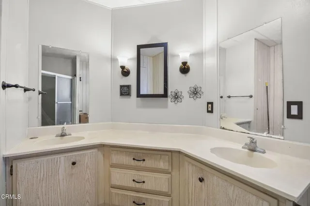 a bathroom with a double vanity sink mirror and
