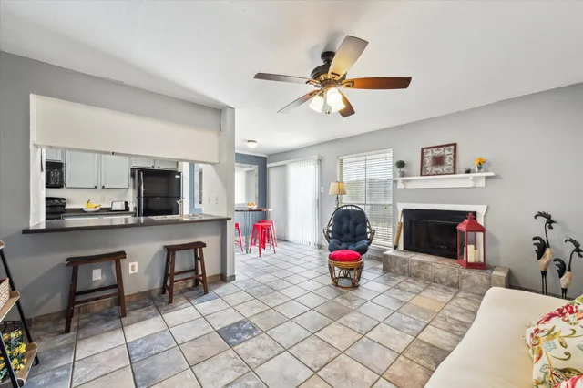 a living room with furniture a fireplace and flat screen tv