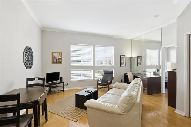a living room with furniture a large window and a table