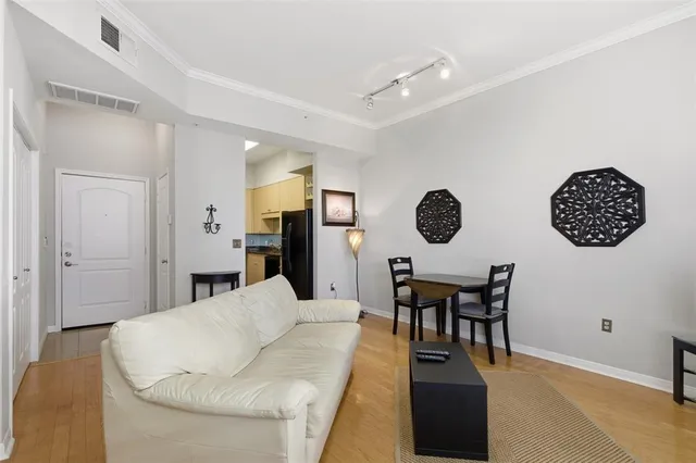 a living room with furniture a table and chairs