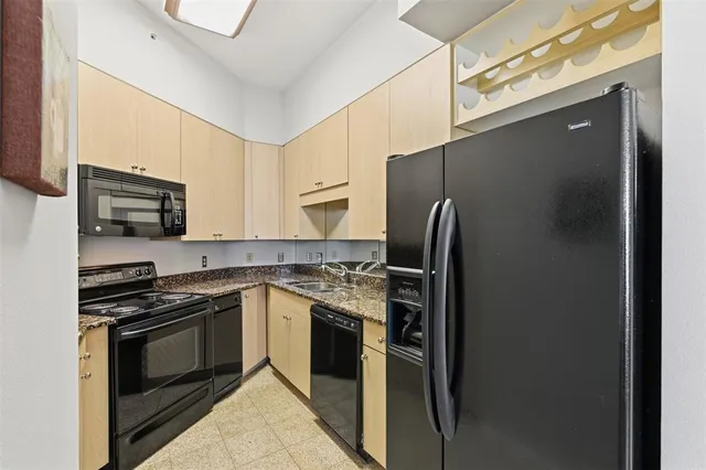 a kitchen with stainless steel appliances granite countertop a refrigerator stove and microwave