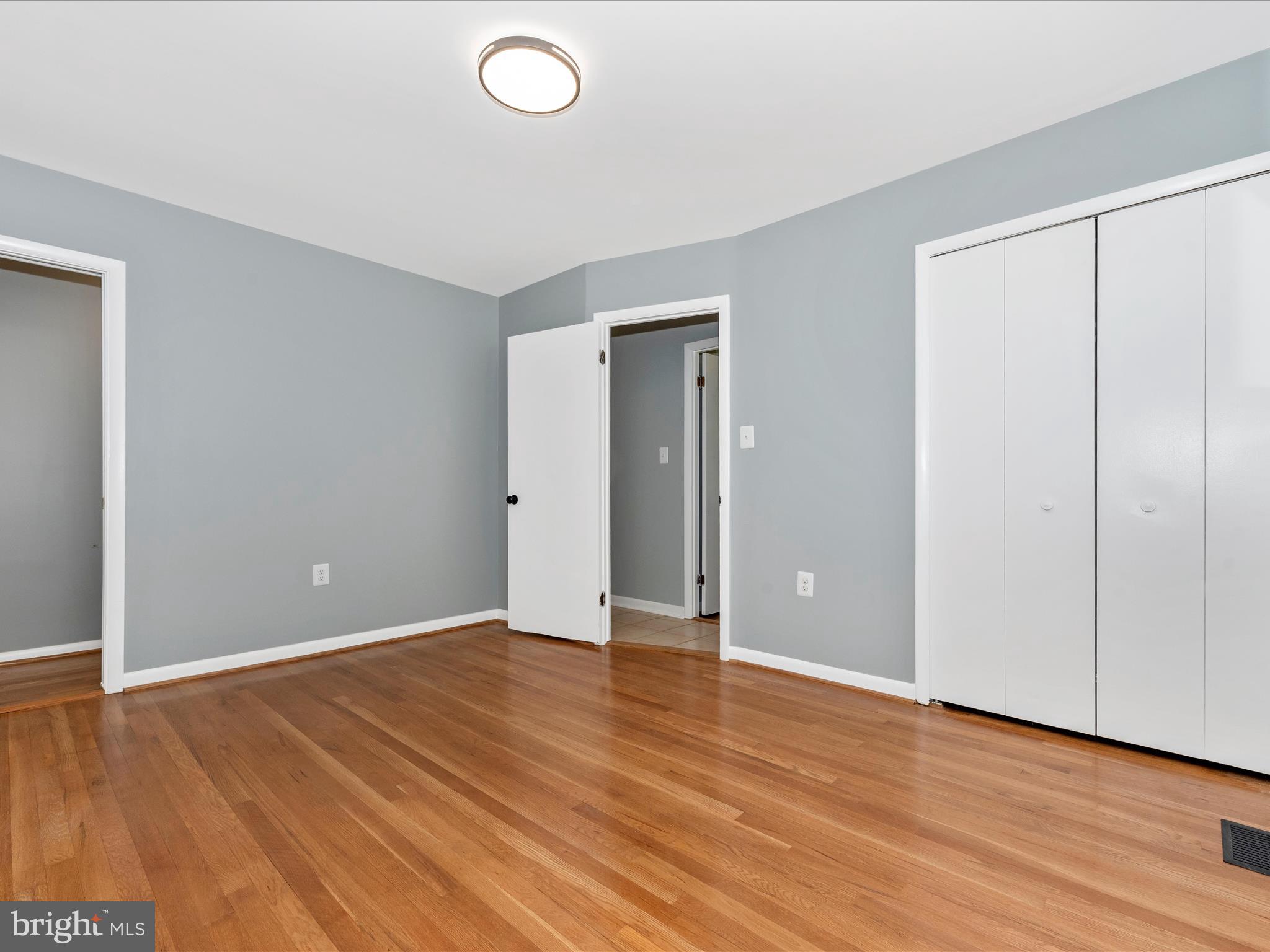 15224 Ganley Road Boyds, MD 20841 - Photo 28 of 62 an empty room with wooden floor and closet