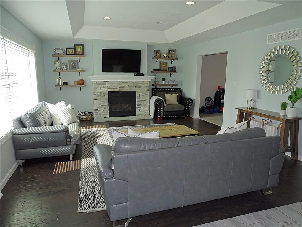 289 Durst Road Irwin, PA 15642 - Photo 12 of 25 FAMILY ROOM WITH STACKED STONE LOOK FIREPLACE AND TRAY CEILING WITH RECESSED LIGHTING