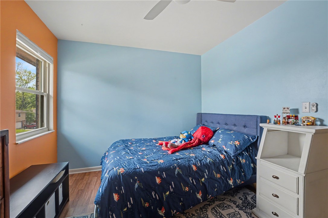 4919 Silver Arrow Drive Riverside, OH 45424 - Photo 22 of 57 This cozy bedroom features hardwood flooring and a ceiling fan, perfect for comfortable living.