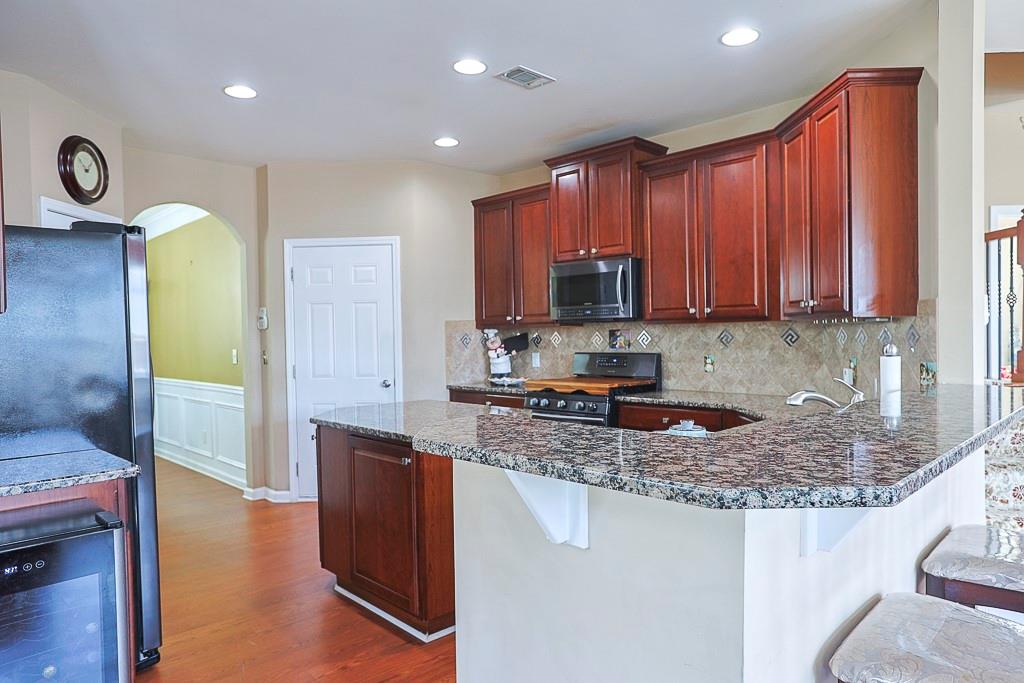 300 Hampton Place Canton, GA 30115 - Photo 18 of 82 a kitchen with stainless steel appliances granite countertop a stove a sink and a microwave