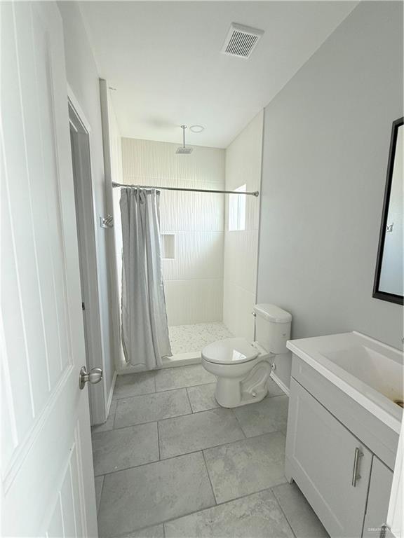1421 North 21st Street, Unit 2 McAllen, TX 78501 - Photo 11 of 13 a bathroom with a toilet a sink and a shower