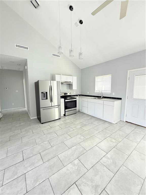 1421 North 21st Street, Unit 2 McAllen, TX 78501 - Photo 2 of 13 a large white kitchen with cabinets and a stove