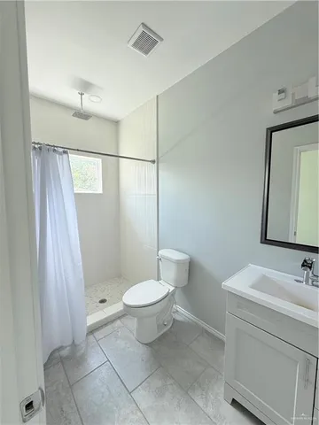 an empty room with a ceiling fan and window