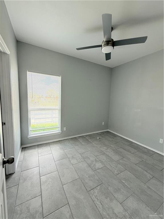1421 North 21st Street, Unit 2 McAllen, TX 78501 - Photo 9 of 13 an empty room with a ceiling fan and window