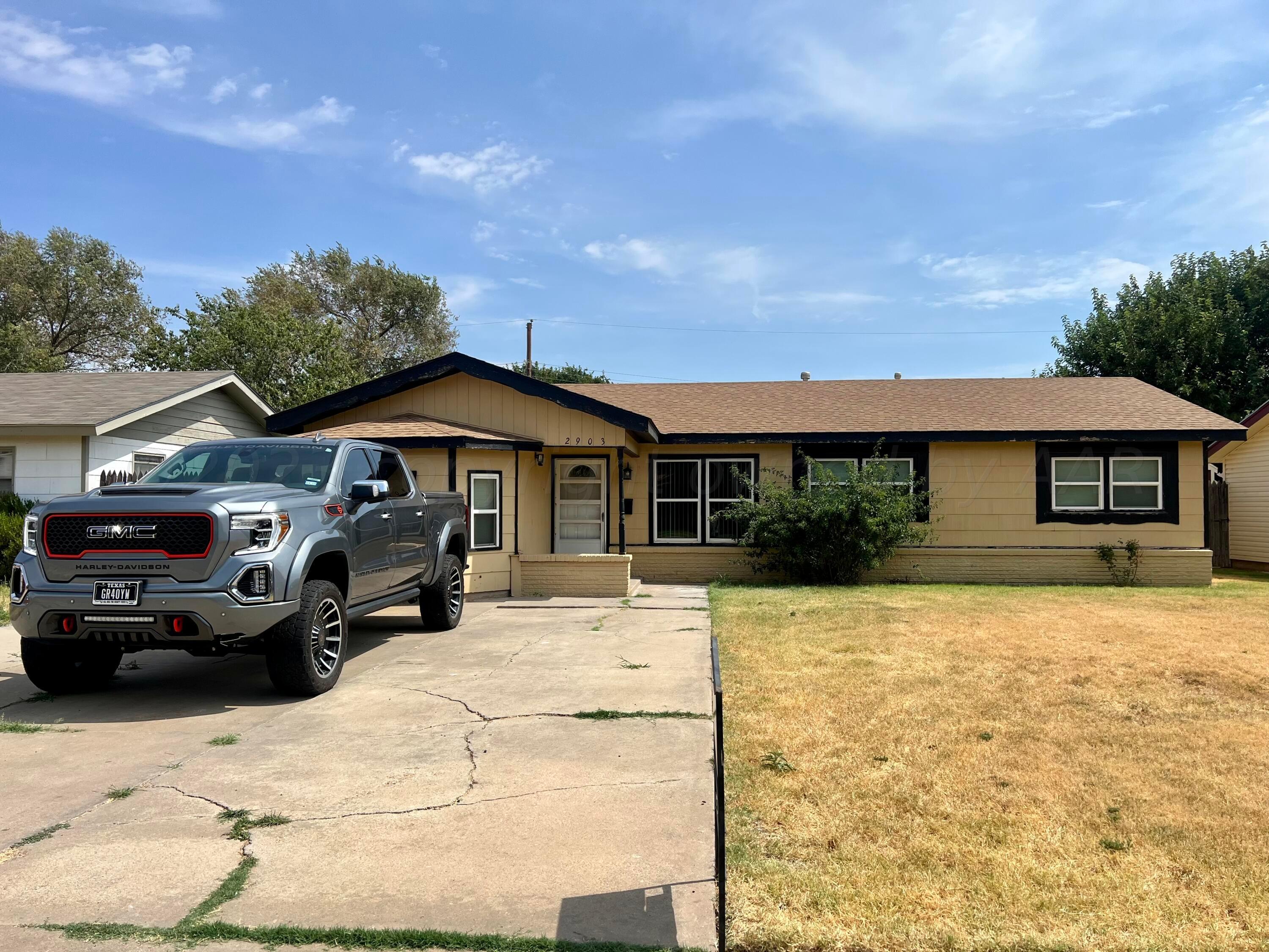 a front view of a house with a yard covered in snow