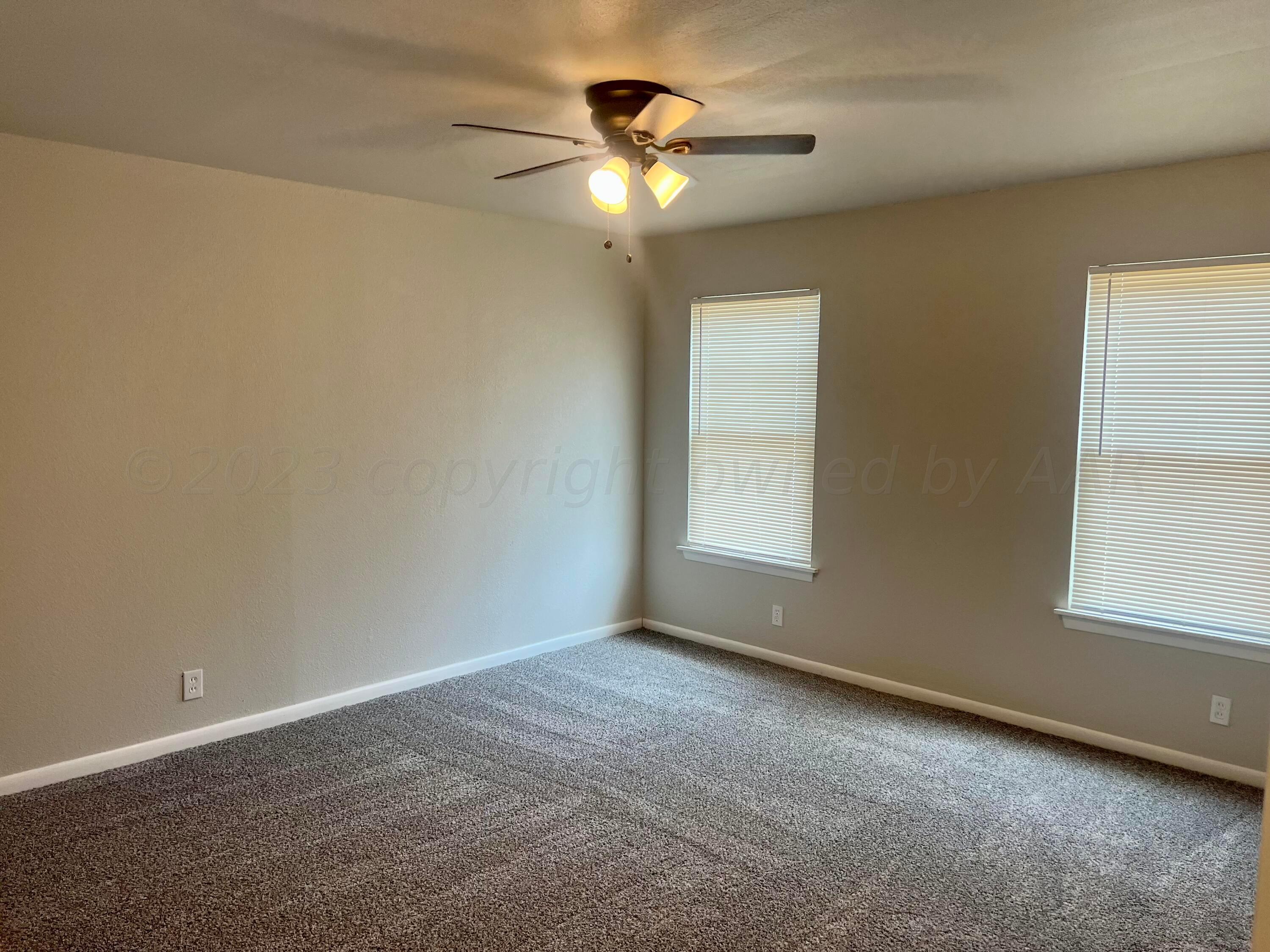 2903 Bagarry Street Amarillo, TX 79103 - Photo 11 of 26 an empty room with a window and a ceiling fan