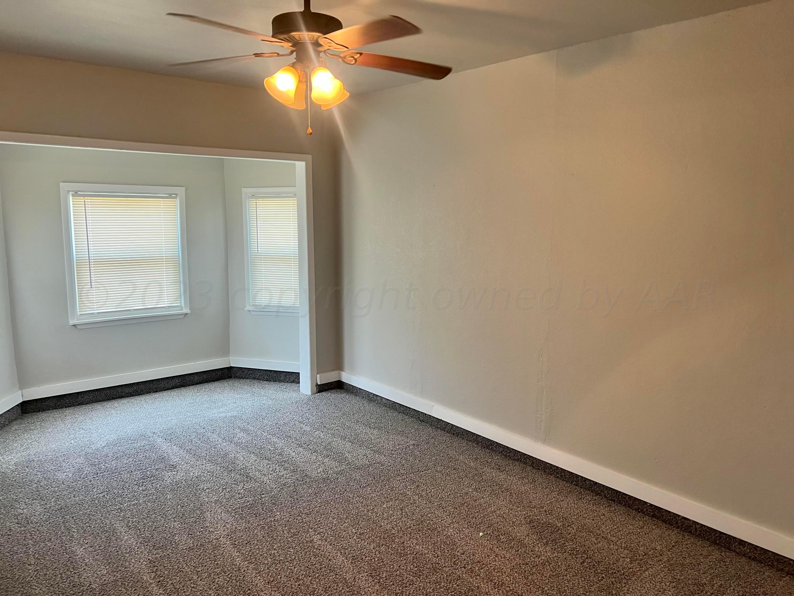 2903 Bagarry Street Amarillo, TX 79103 - Photo 14 of 26 wooden floor in an empty room with a window