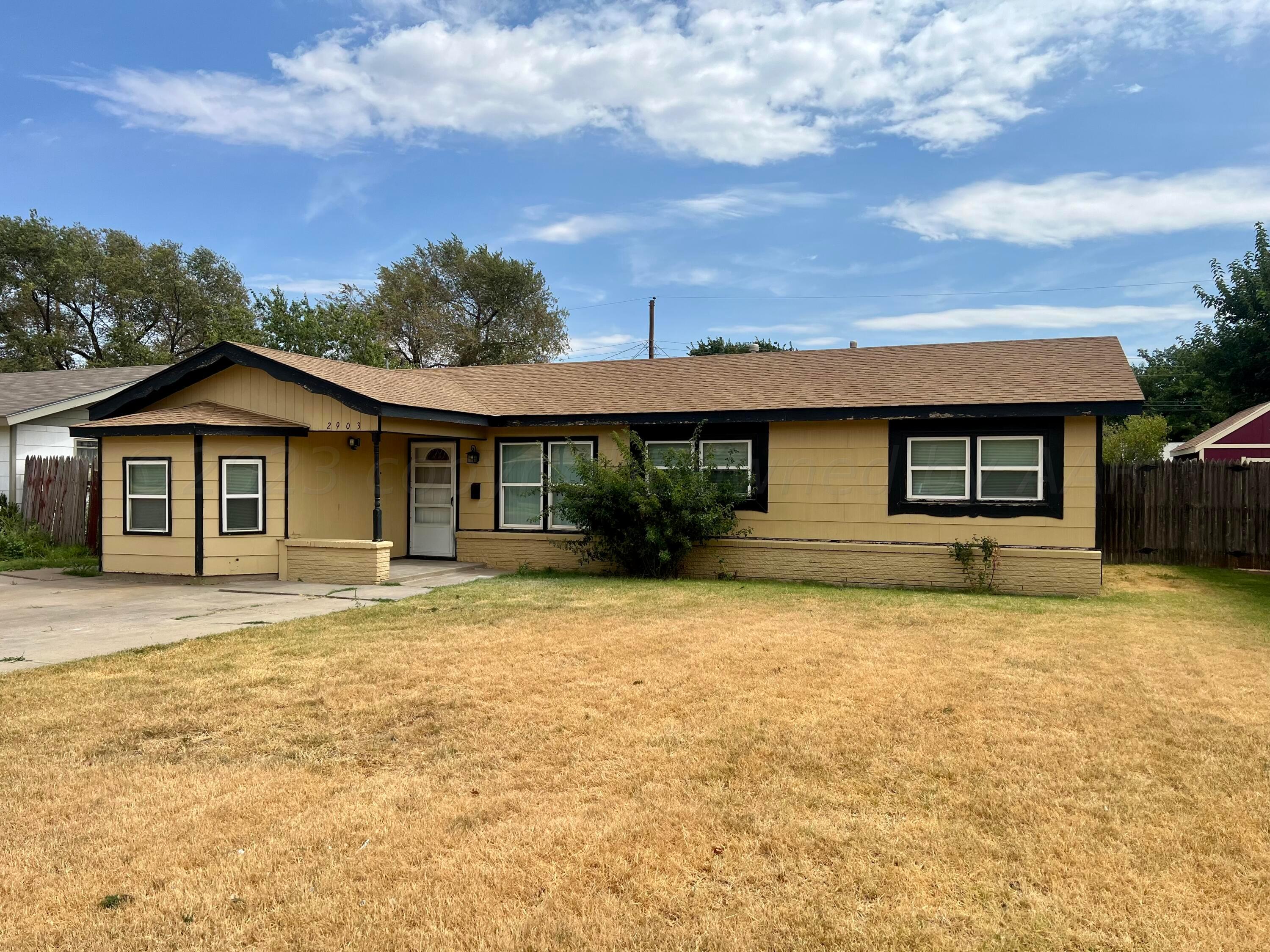 2903 Bagarry Street Amarillo, TX 79103 - Photo 2 of 26 a front view of a house with a garden