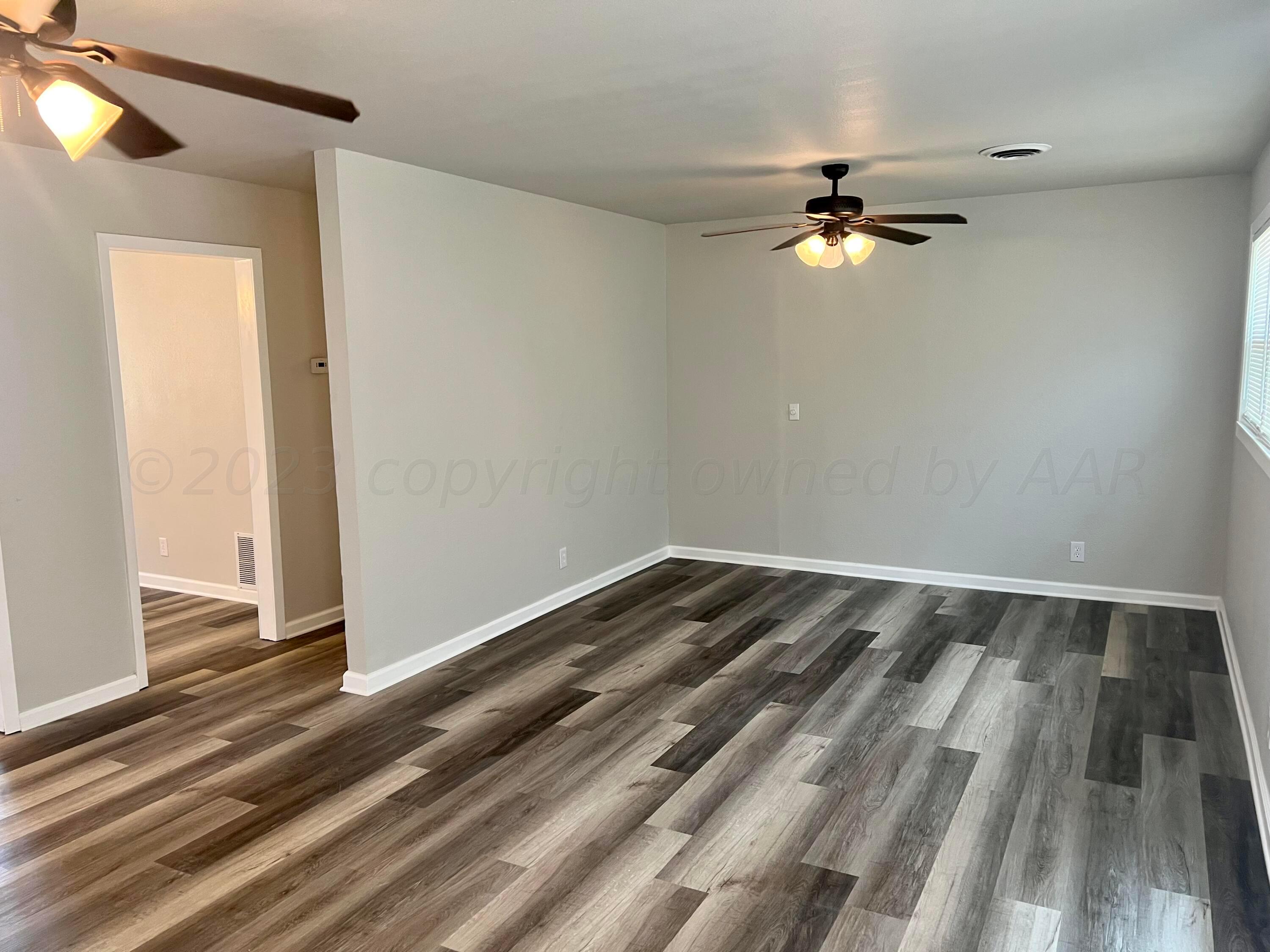 2903 Bagarry Street Amarillo, TX 79103 - Photo 4 of 26 a view of empty room with wooden floor and fan