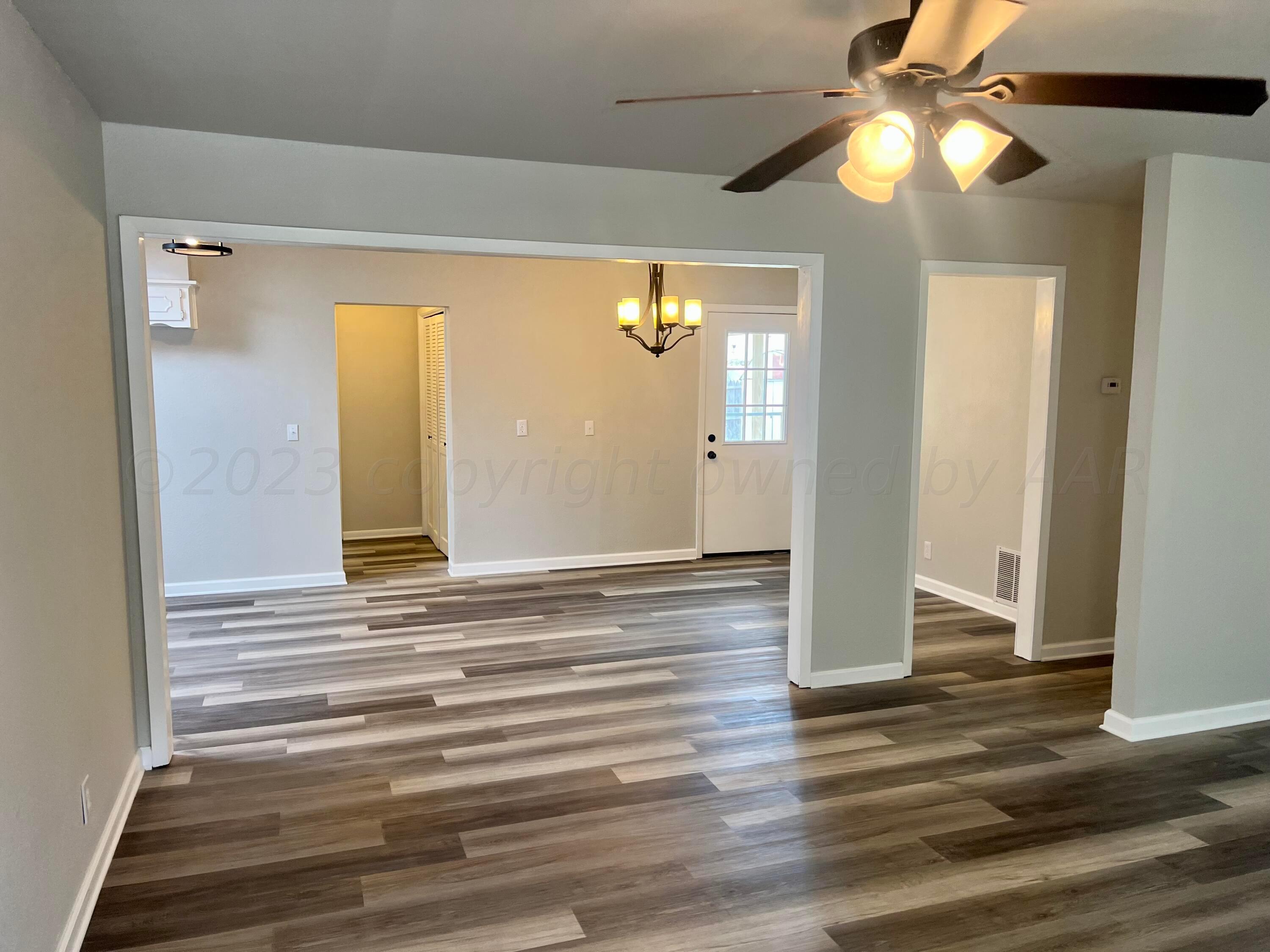 2903 Bagarry Street Amarillo, TX 79103 - Photo 5 of 26 a view of an empty room with wooden floor and a window