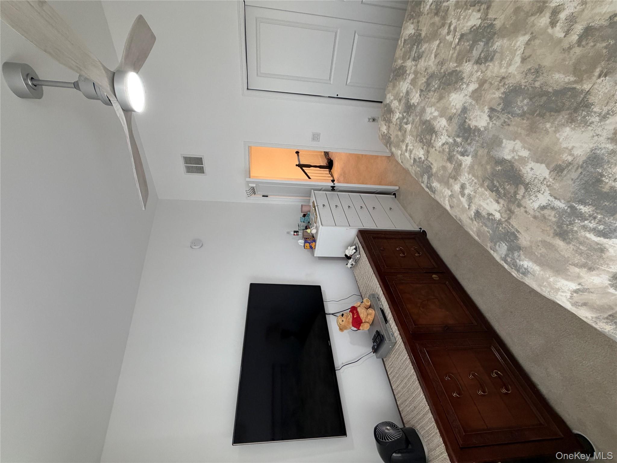 45 Lewis Road Hopewell Junction, NY 12533 - Photo 12 of 34 a bedroom with a bed and a flat screen tv