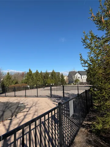 a big yard with trees in the background