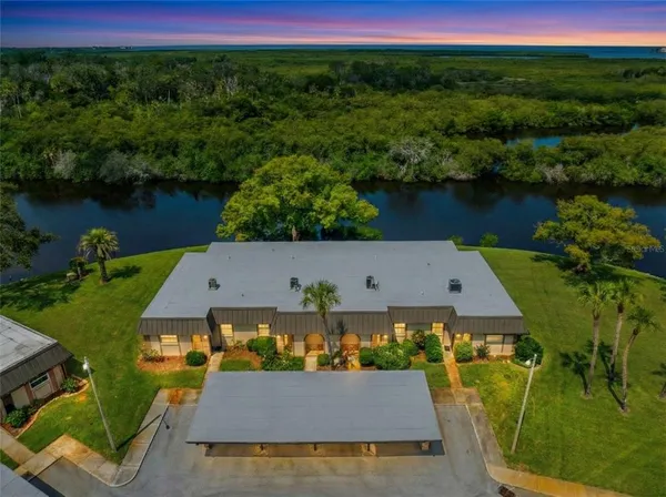 an aerial view of a house with pool lake view and mountain view