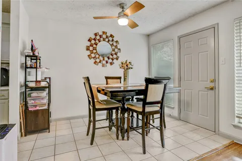 a dining room with furniture and chandelier