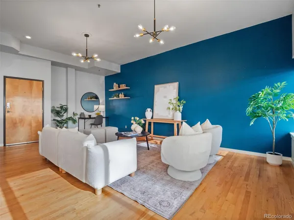 a living room with furniture and a chandelier