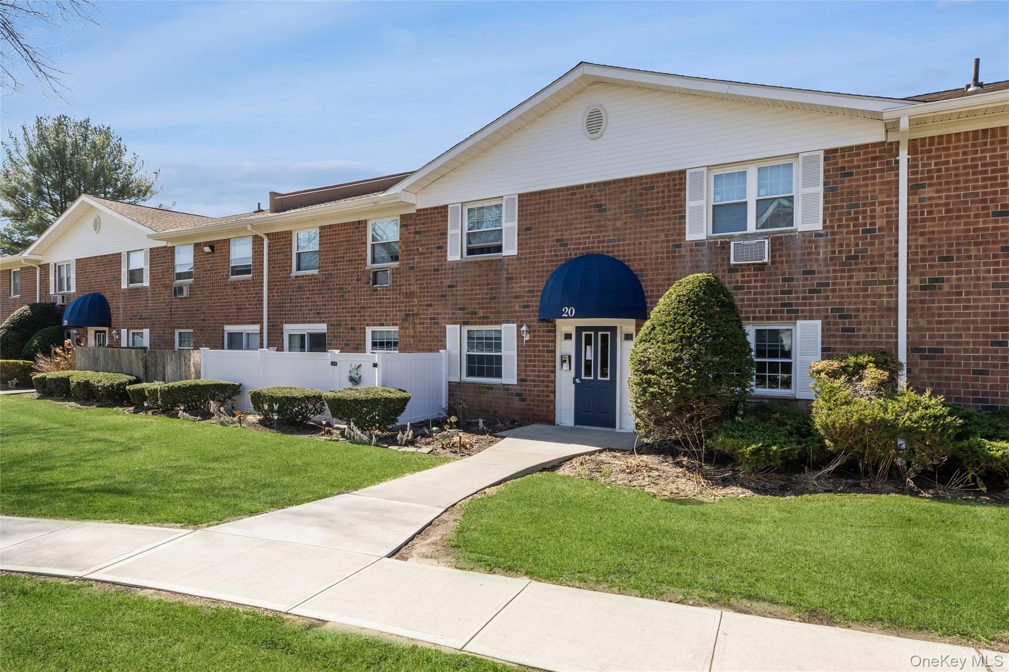 460 Old Town Road, Unit 20F Port Jefferson Station, NY 11776 - Photo 1 of 22 a front view of a house with a garden and yard