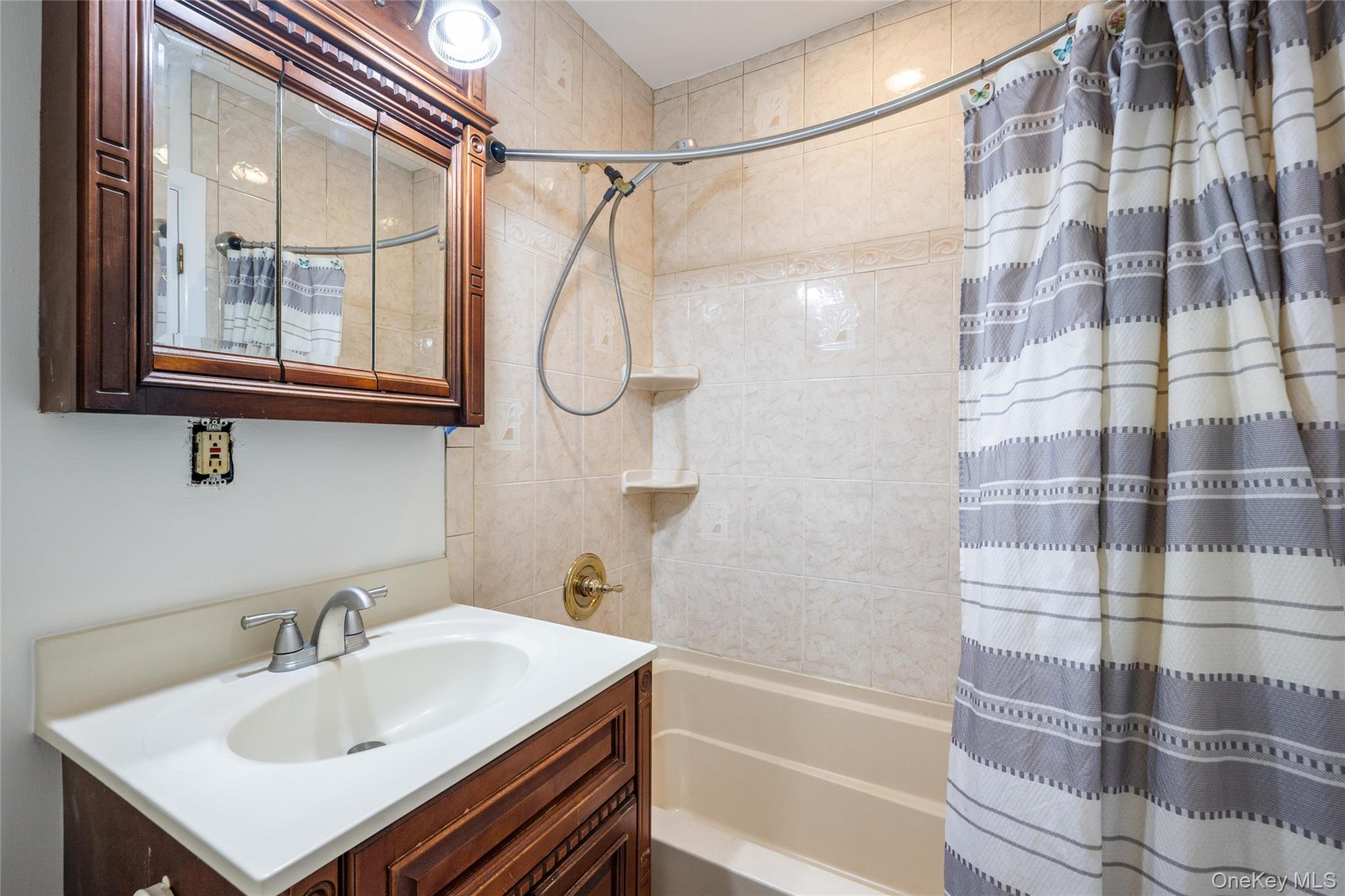 460 Old Town Road, Unit 20F Port Jefferson Station, NY 11776 - Photo 13 of 22 a bathroom with a sink a mirror and a shower