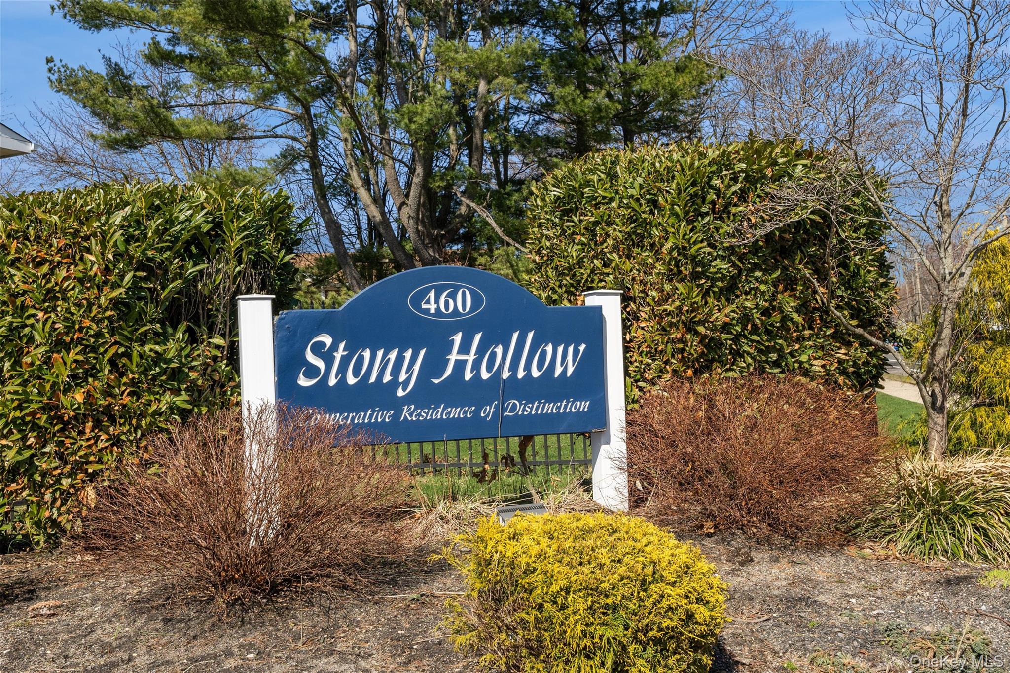 460 Old Town Road, Unit 20F Port Jefferson Station, NY 11776 - Photo 2 of 22 a sign on the side of the road