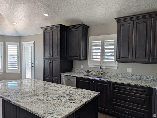 171 South Mustang Road East Grantsville, UT 84029 - Photo 8 of 41 Spacious kitchen featuring dark wood cabinetry, light-toned patterned countertops, and a large central island