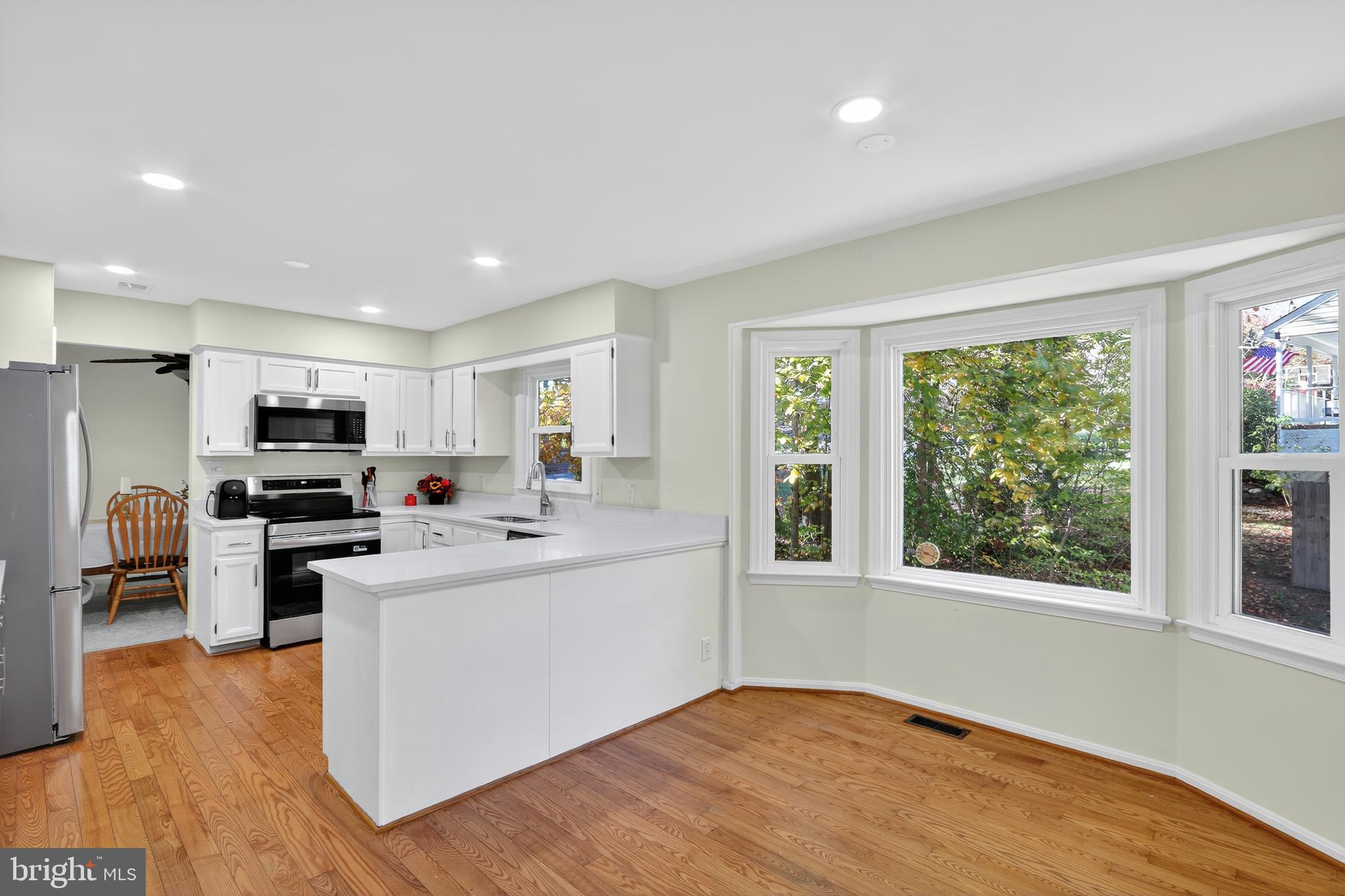 111 Oaklawn Road Stafford, VA 22554 - Photo 18 of 50 a kitchen with stainless steel appliances kitchen island wooden floor and window