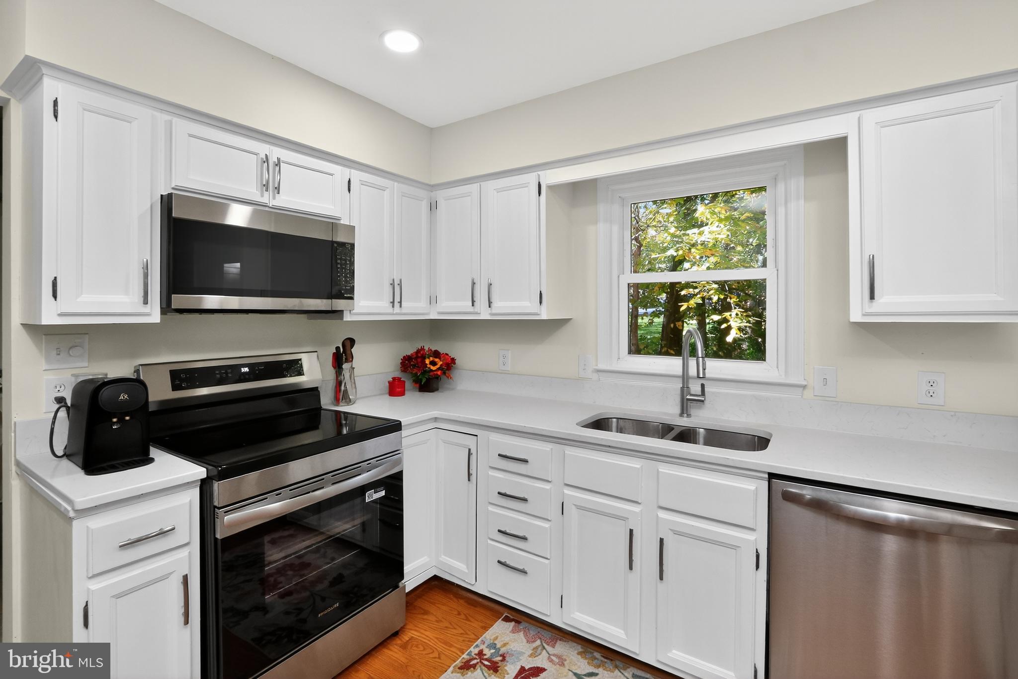 111 Oaklawn Road Stafford, VA 22554 - Photo 22 of 50 a kitchen with white cabinets stainless steel appliances and a sink