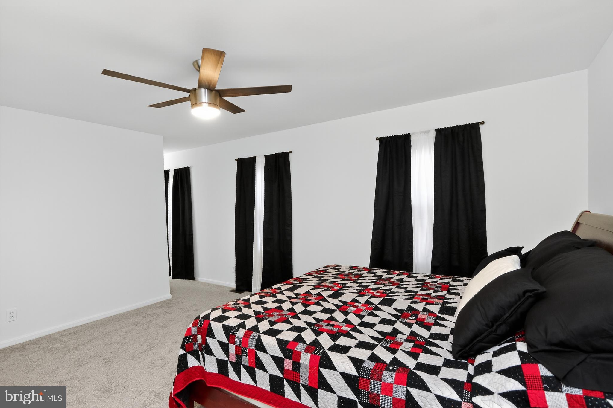 111 Oaklawn Road Stafford, VA 22554 - Photo 30 of 50 a bedroom with a bed and a chandelier