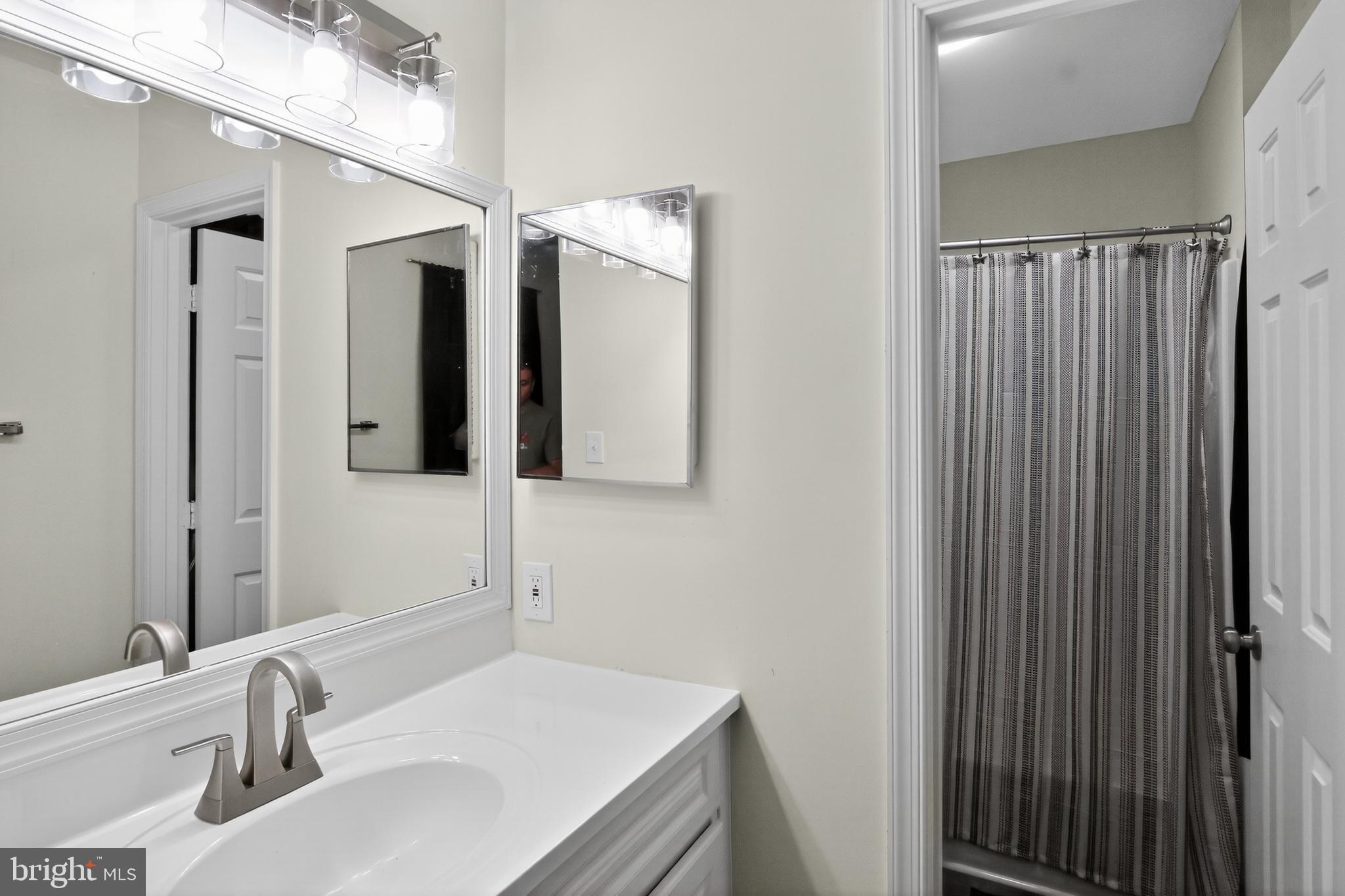 111 Oaklawn Road Stafford, VA 22554 - Photo 36 of 50 a bathroom with a sink and a mirror