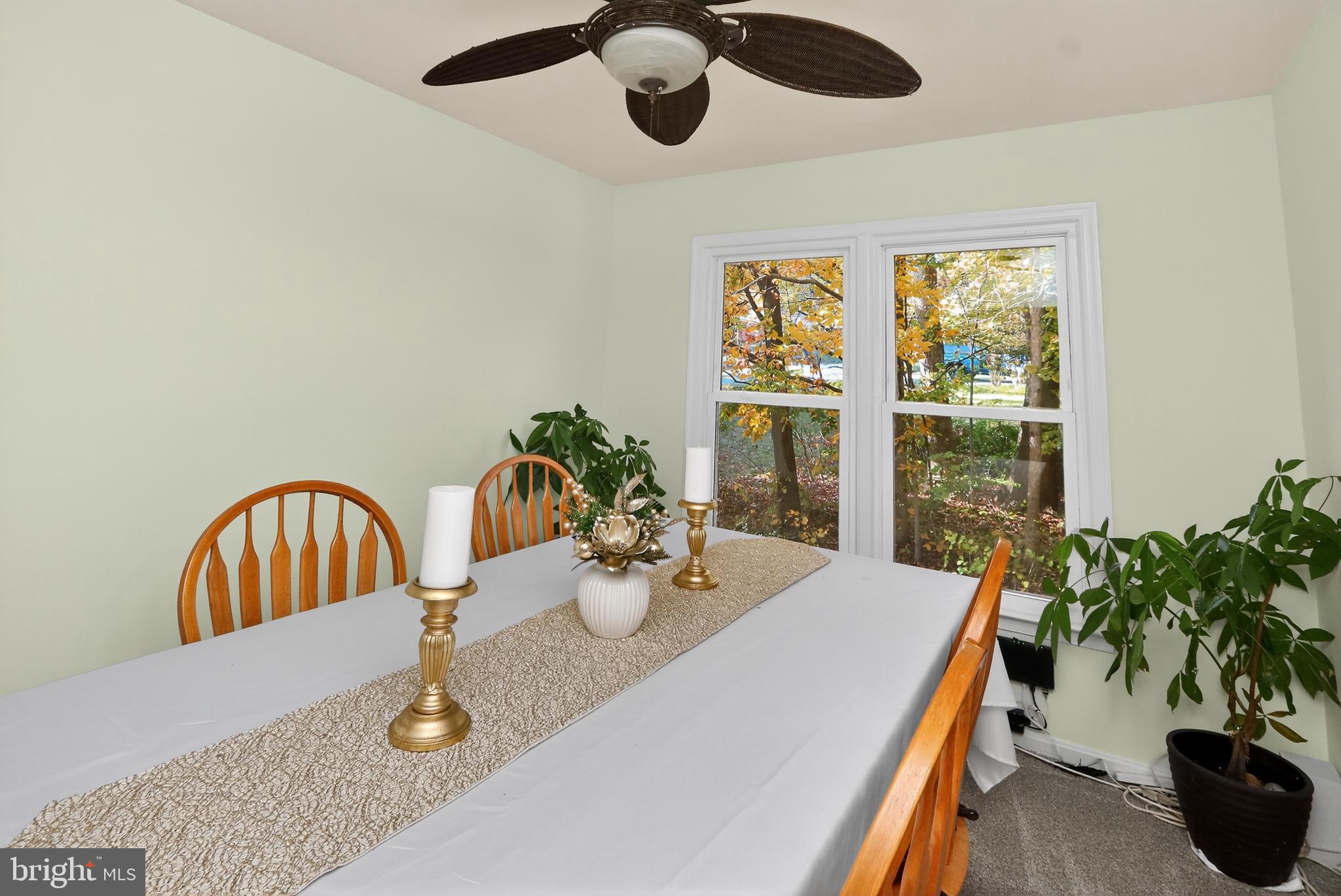 111 Oaklawn Road Stafford, VA 22554 - Photo 5 of 50 a dining room with furniture potted plants and wooden floor