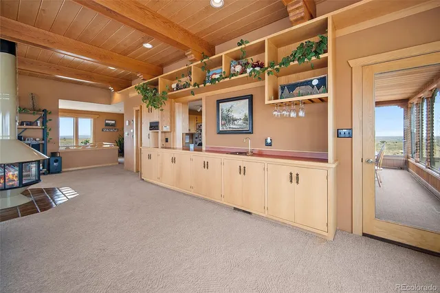 a hall with a large mirror and a sink