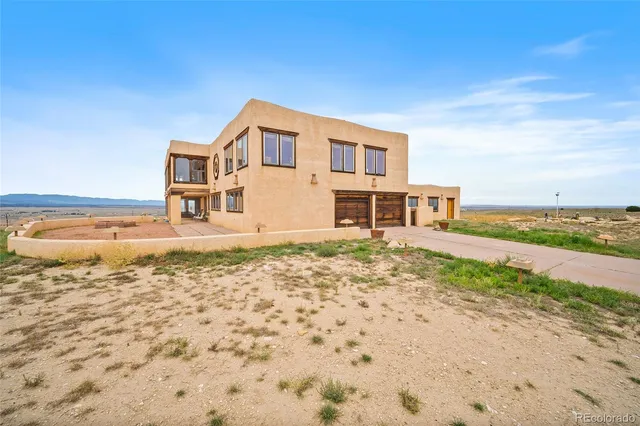 a house view with a ocean beach