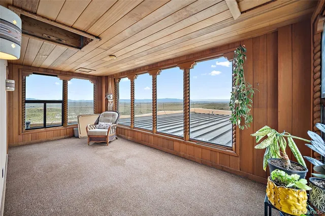 a living room with furniture and a floor to ceiling window