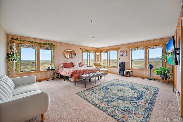 a bedroom with a large bed and a couch