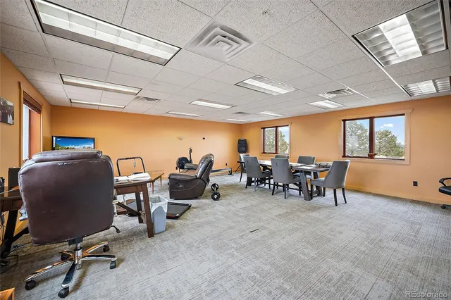 a view of a room with chairs and a table