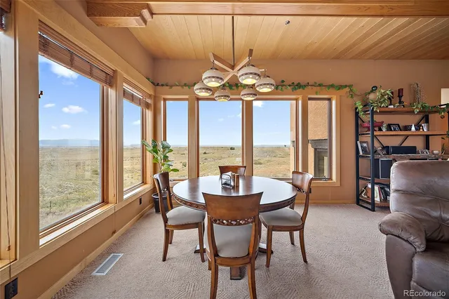 a dining room with furniture a chandelier and a rug