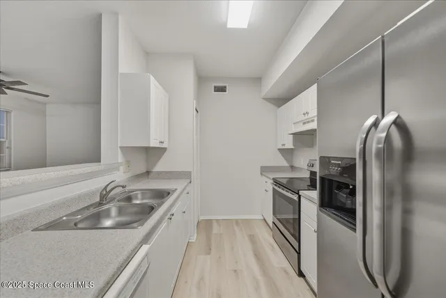 a view of kitchen island with cabinets
