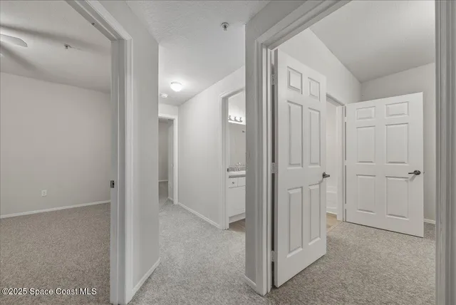 a view of an empty room and a bathroom