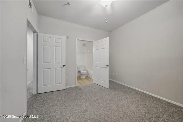 a bathroom with a granite countertop sink a toilet and bathtub