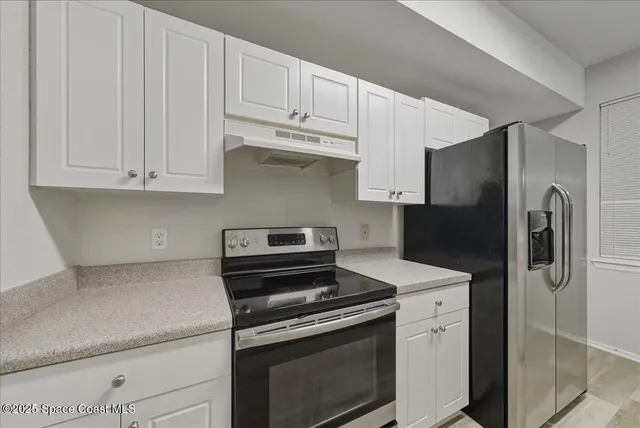 a kitchen with a sink stove and refrigerator