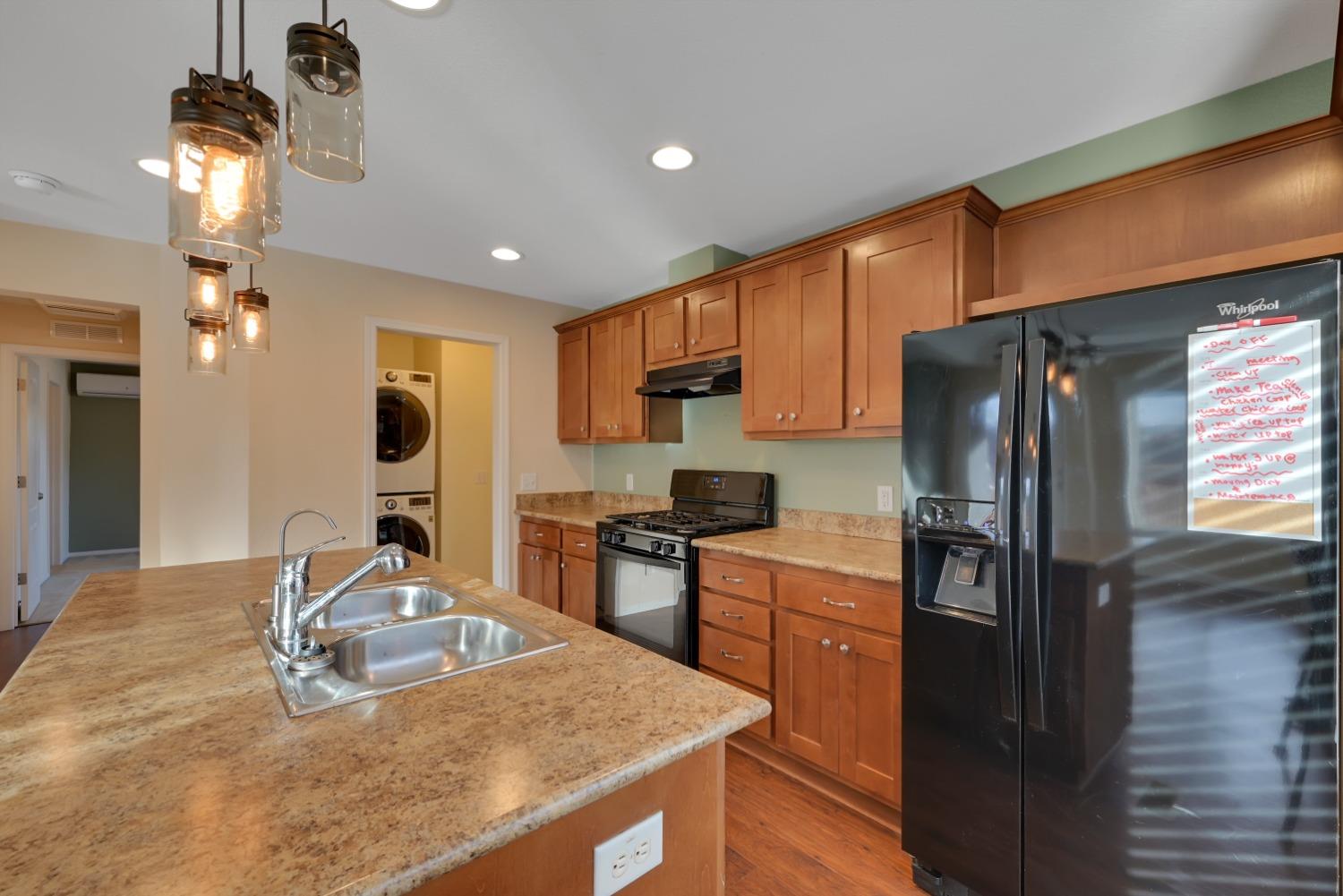 4485 Sites Lodoga Road Stonyford, CA 95979 - Photo 21 of 66 a kitchen with stainless steel appliances granite countertop a sink refrigerator and cabinets