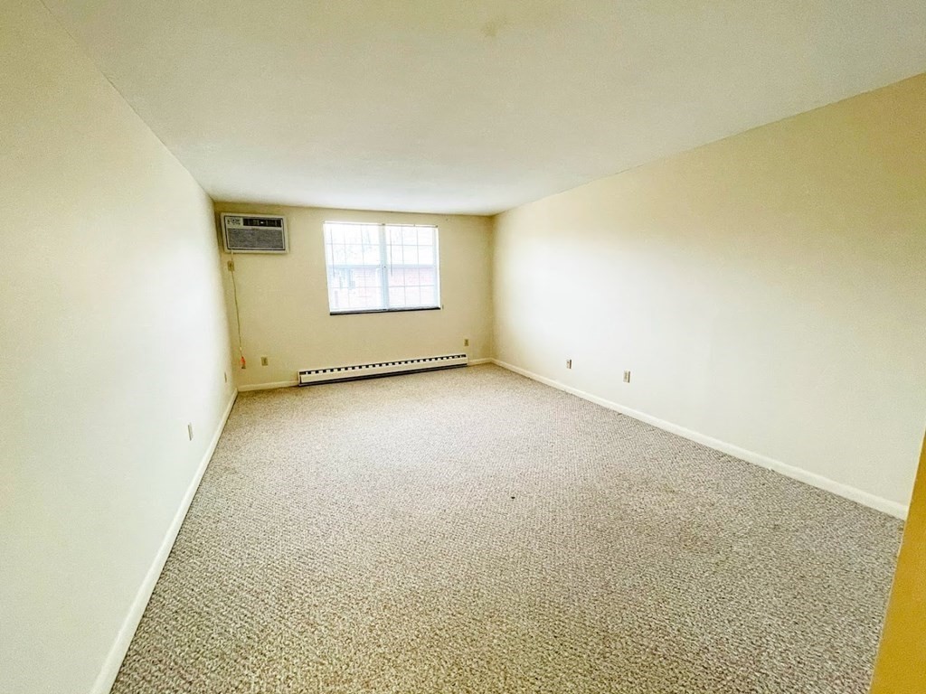 63 Leonard Road, Unit 63 Boxborough, MA 01719 - Photo 13 of 17 an empty room with a empty space and windows