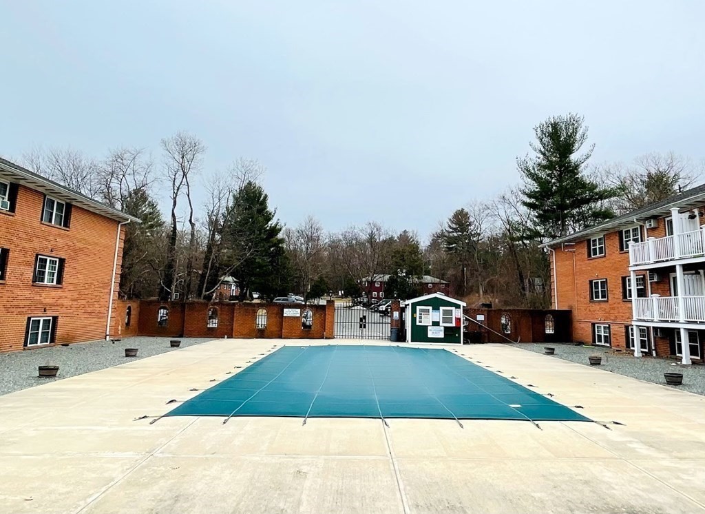 63 Leonard Road, Unit 63 Boxborough, MA 01719 - Photo 15 of 17 a view of street with houses and trees in the background